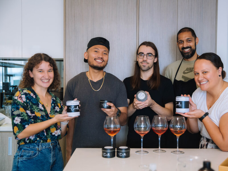 A group of adult friends show their handmade candles